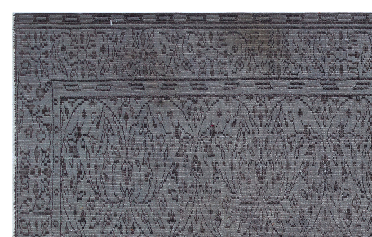 Charcoal and grey rug with a traditional floral medallion border and an intricate, repeating damask-style pattern.