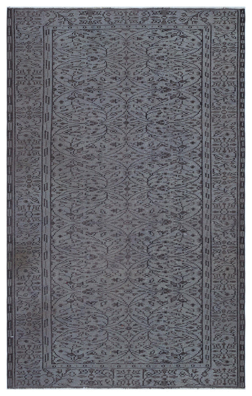 Load image 1 in gallery view. Charcoal grey rug with a repeating botanical trellis pattern and a geometric border on a white background.