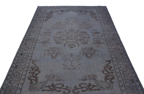 Load image 1 in gallery view. Grey and brown distressed rug with a central floral medallion and ornate border pattern on a white background.