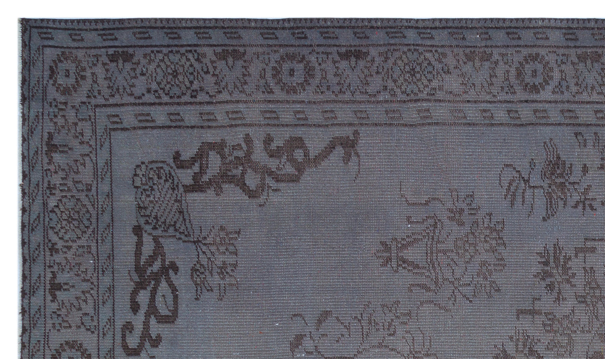 Charcoal grey rug with a dark brown traditional floral border and central medallion pattern.