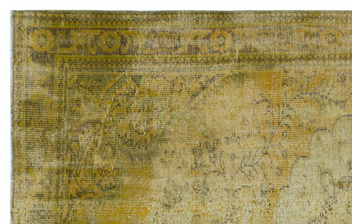 Load image 1 in gallery view. Distressed vintage-style rug in shades of mustard yellow and olive green with a faded traditional border pattern.