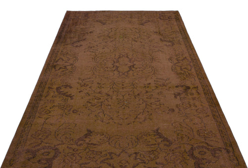 Load image 1 in gallery view. Monochromatic brown vintage-style rug with a faint, distressed floral medallion pattern.