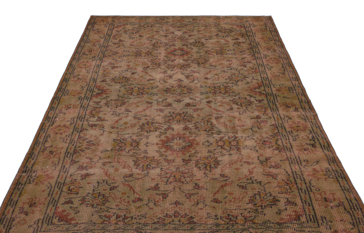 Distressed brown and rust-toned traditional rug with a faded floral medallion pattern and a geometric border.
