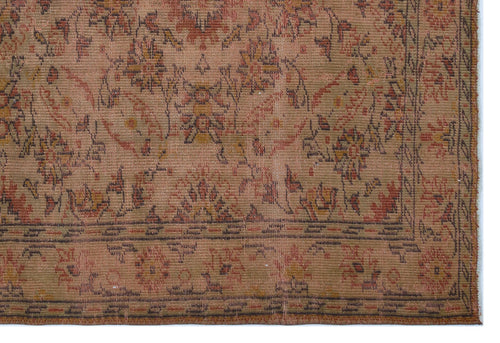 Load image 1 in gallery view. Distressed tan rug with a faded floral medallion pattern in rust, olive, and charcoal, featuring a detailed border.