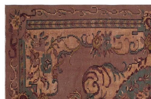 Load image 1 in gallery view. Brown traditional rug with a distressed floral medallion pattern in muted green, tan, and dark red accents.