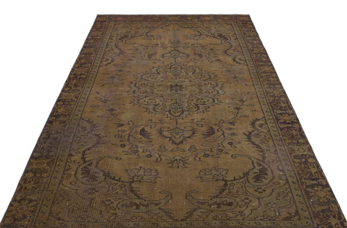 Load image 1 in gallery view. Distressed brown and dark olive traditional rug with a central floral medallion and ornate border.