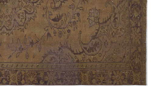 Load image 1 in gallery view. Distressed brown and olive green rug with a traditional floral medallion pattern and a detailed geometric border.