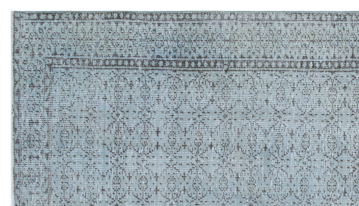 Light blue and grey rug with a distressed traditional medallion pattern and a detailed border.