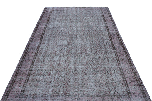 Load image 1 in gallery view. Distressed mauve and grey vintage-style rug with a traditional floral medallion pattern and a dark border.