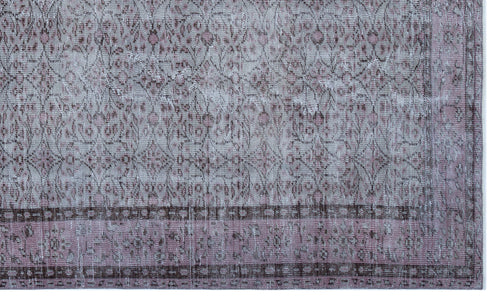 Load image 1 in gallery view. Distressed mauve and grey rug with a traditional floral medallion pattern and a geometric border.