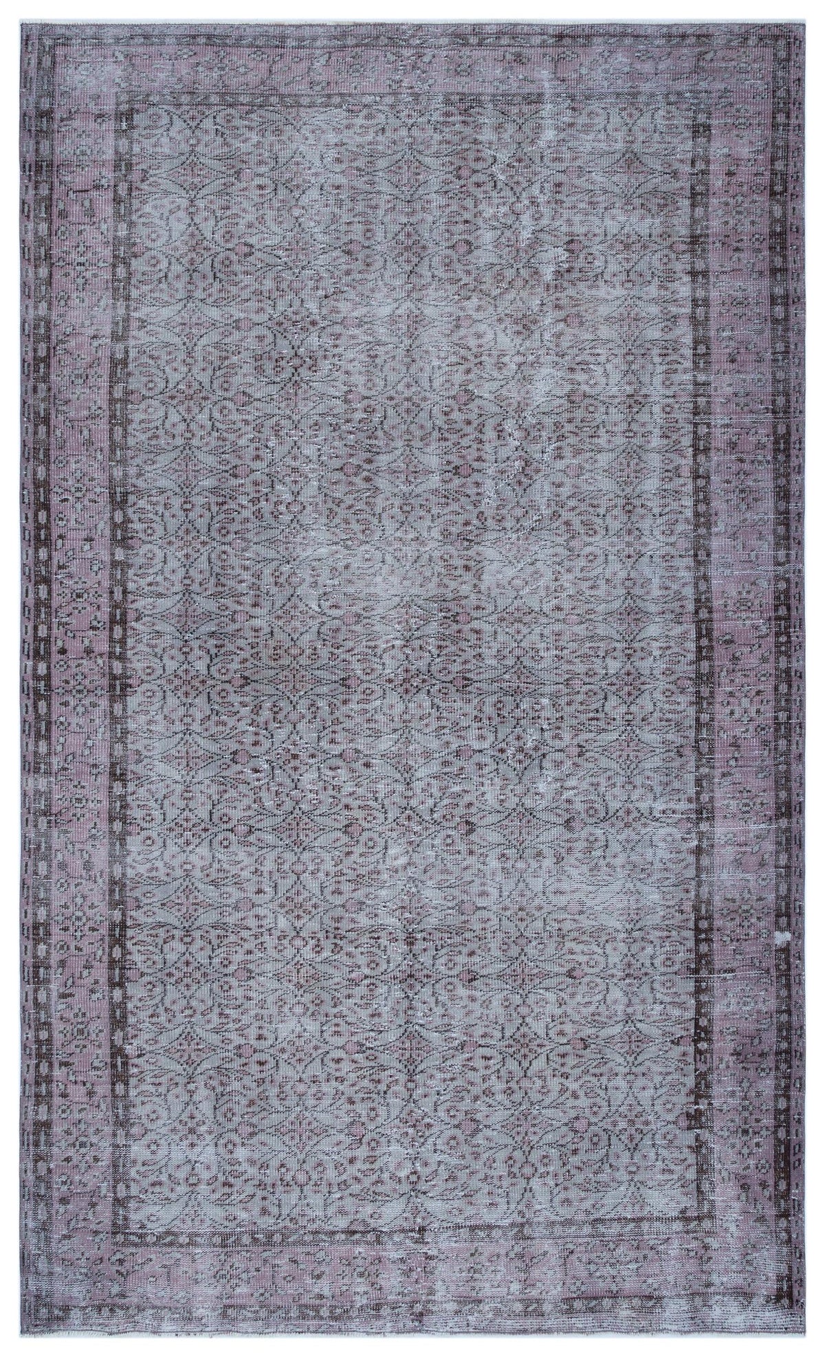 Distressed mauve and grey area rug with a traditional floral vine pattern and a bordered geometric frame.