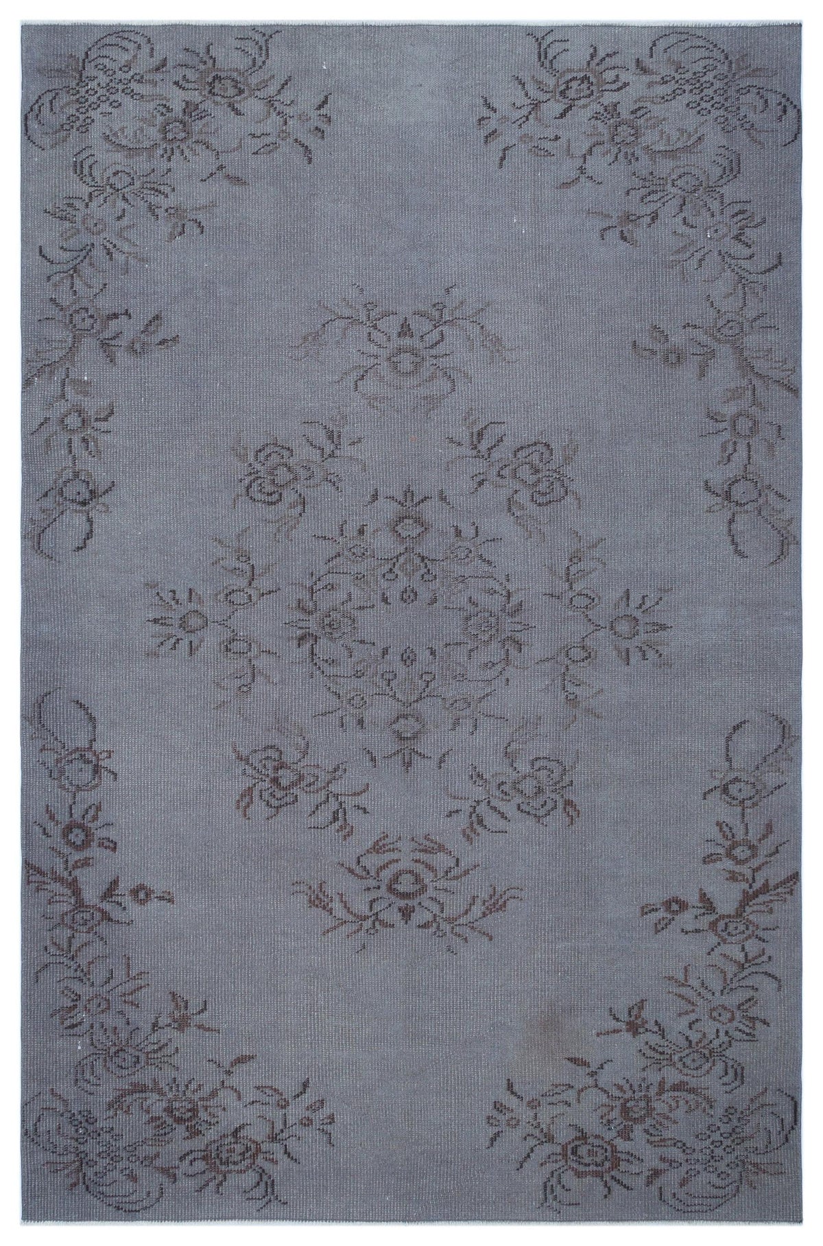 Slate blue distressed rug with a dark grey floral medallion and border pattern.