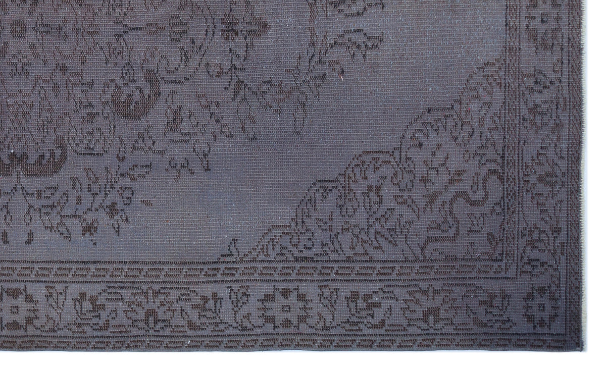 Dark charcoal monochromatic rug with a traditional floral medallion pattern and a detailed border.