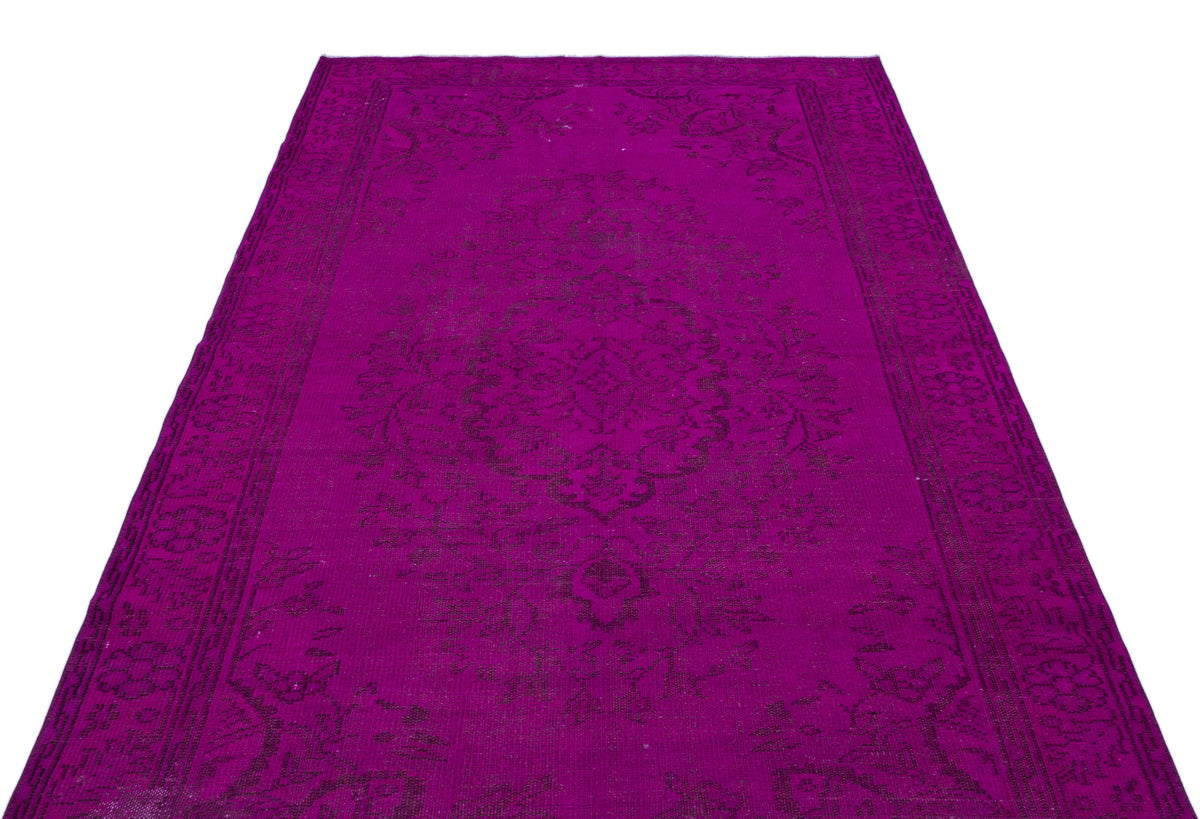 Magenta vintage-style rug with a dark purple traditional floral medallion pattern and a decorative border.