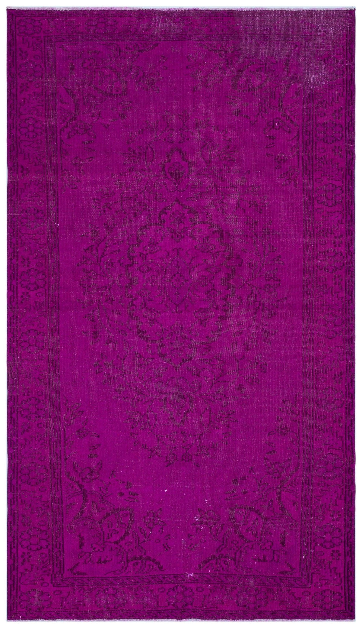 Magenta overdyed vintage rug with a dark floral medallion pattern and a decorative border.