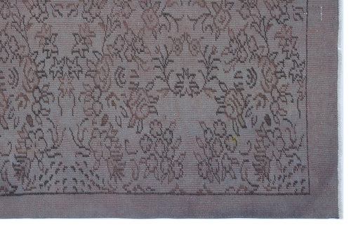 Load image 1 in gallery view. Muted mauve and brown rug with a traditional floral medallion pattern and a solid border.