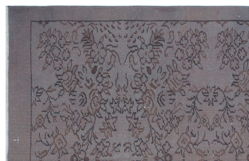 Load image 1 in gallery view. Dark brown monochromatic rug with a distressed, traditional floral medallion pattern and a simple border.