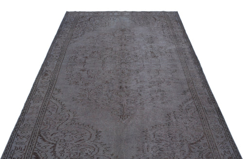 Load image 1 in gallery view. Charcoal grey vintage-style rug with a faded traditional medallion pattern and ornate border on a white background.