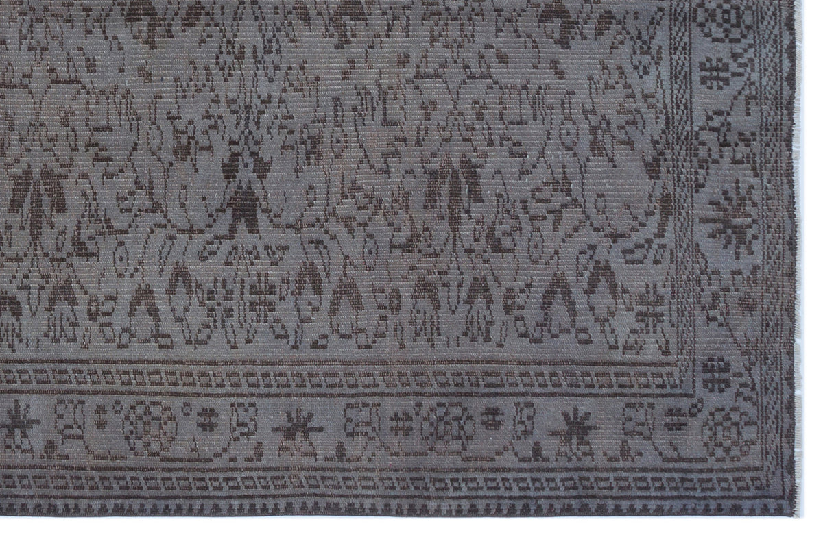 Charcoal grey rug with a traditional floral medallion pattern and a detailed geometric border.