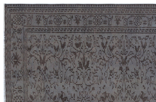 Load image 1 in gallery view. Dark gray and brown rug with a traditional floral medallion border and intricate botanical pattern.