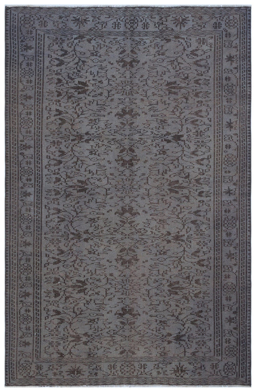 Load image 1 in gallery view. Charcoal grey rug with a distressed traditional floral medallion pattern and a geometric border.