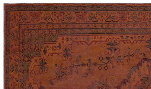 Load image 1 in gallery view. Rust-colored traditional rug with dark green and black geometric and floral border patterns.