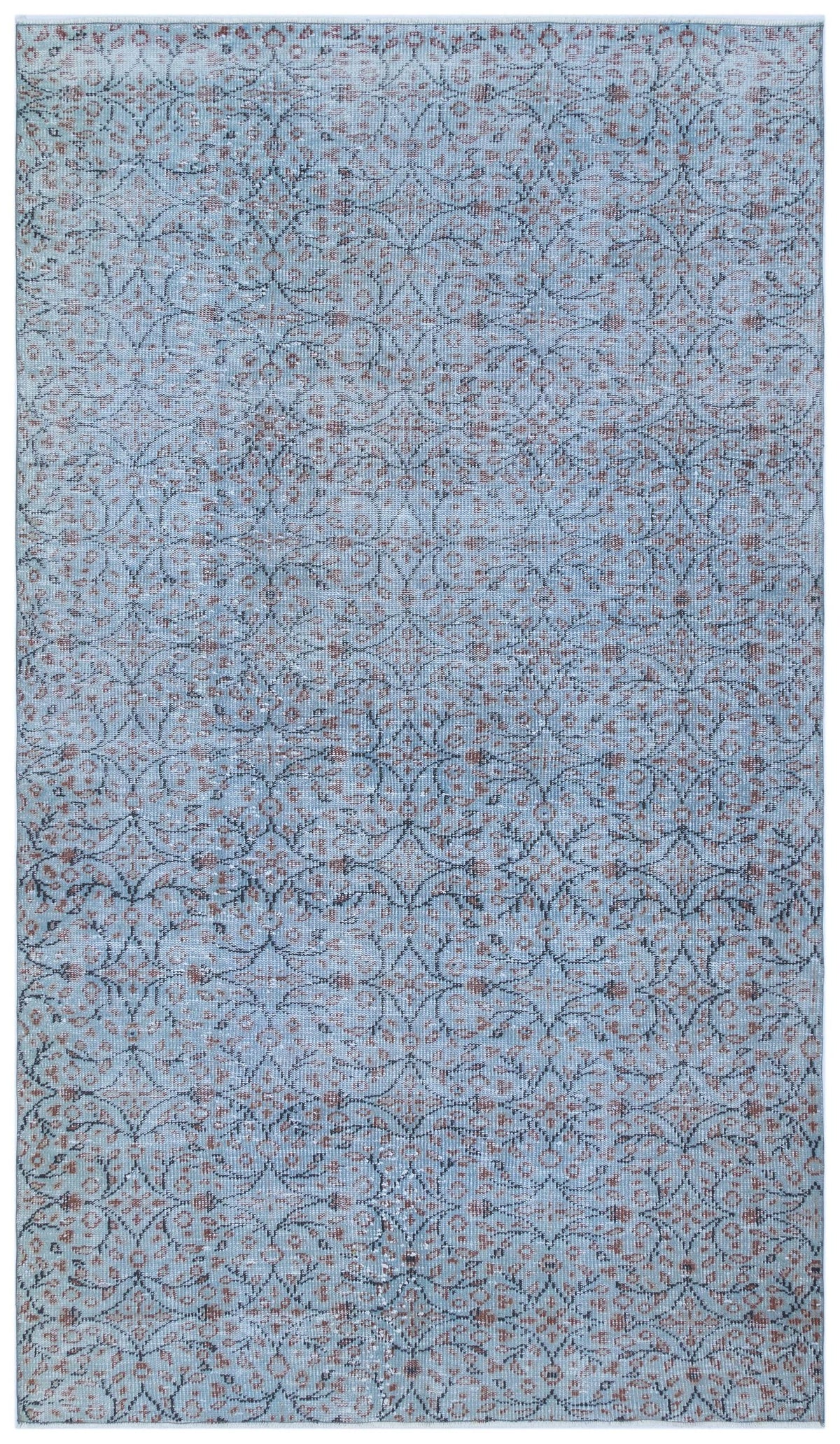Light blue rug with a distressed, repeating dark grey and rust-colored floral medallion pattern.