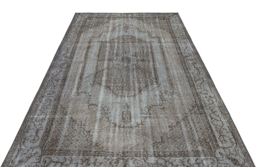 Load image 1 in gallery view. Distressed brown and beige vintage-style rug with a central medallion and ornate border on a white background.