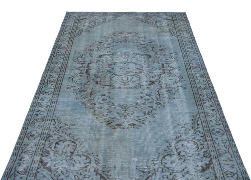 Load image 1 in gallery view. Distressed light blue rug with a dark grey traditional floral medallion pattern and a decorative border.