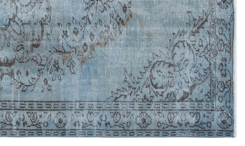 Load image 1 in gallery view. Light blue distressed rug with a dark brown floral medallion pattern and a geometric border.