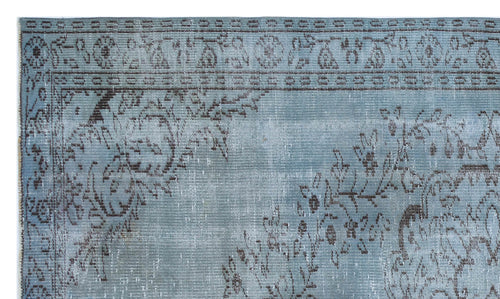 Load image 1 in gallery view. Dusty blue rug with a dark grey distressed floral medallion pattern and a decorative border.