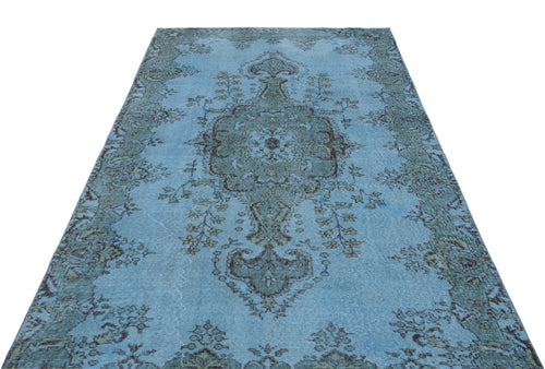 Load image 1 in gallery view. Light blue distressed rug with a dark grey central floral medallion and ornate border pattern.