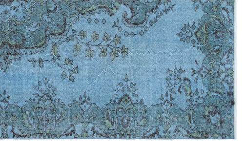 Load image 1 in gallery view. Light blue rug with a distressed, dark brown and sage green traditional floral medallion pattern.