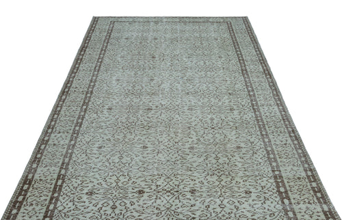 Load image 1 in gallery view. Light gray and brown vintage-style rug with an intricate floral medallion pattern and a double-bordered edge.