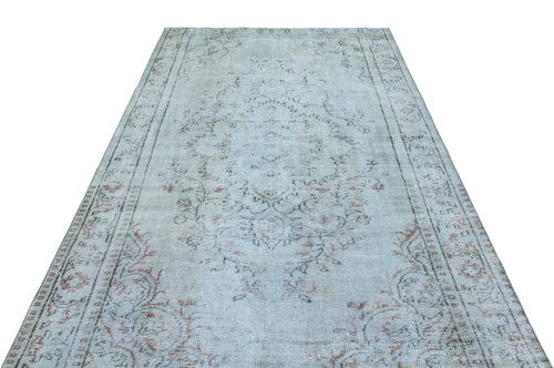Load image 1 in gallery view. Light blue and beige vintage-style rug with a faded central medallion and ornate floral border.