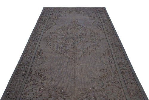 Load image 1 in gallery view. Dark charcoal distressed rug with a traditional central medallion and ornate border pattern on a white background.