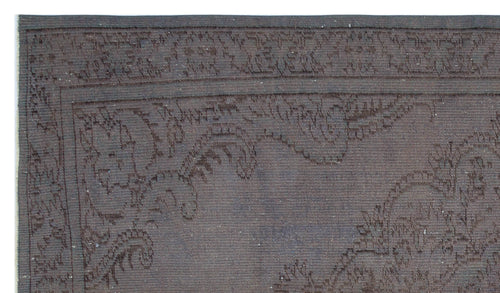 Load image 1 in gallery view. Dark charcoal rug with a subtle, tonal floral border and central medallion pattern.
