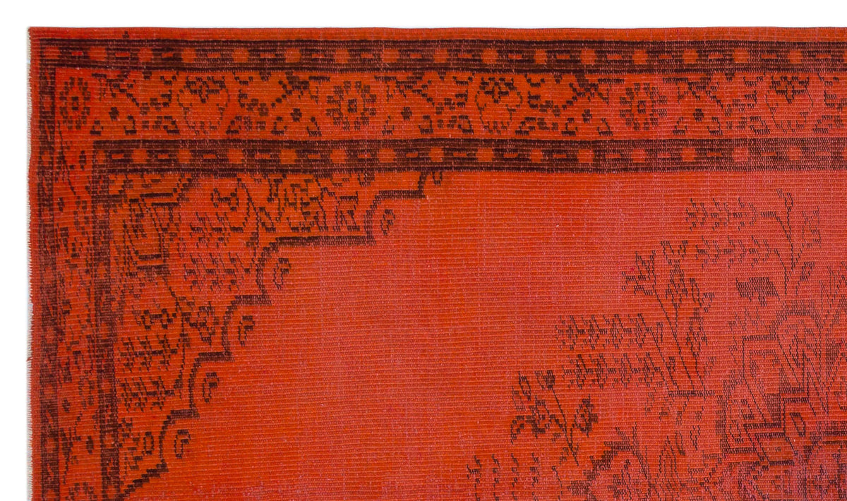 Bright orange rug with a dark brown traditional floral border and central medallion pattern.
