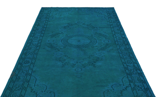 Load image 1 in gallery view. Teal monochromatic rug with a central medallion and traditional border pattern on a white background.