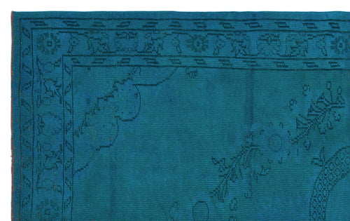 Load image 1 in gallery view. Teal rug with a dark blue linear border and subtle floral corner motifs.