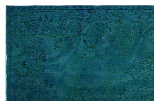 Load image 1 in gallery view. Teal monochromatic rug with a subtle, distressed traditional floral medallion pattern.