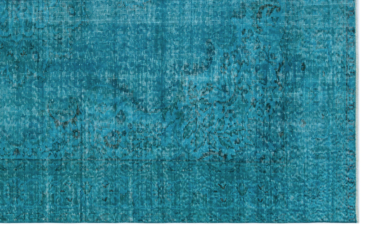 Teal distressed rug with a faded traditional floral medallion pattern.