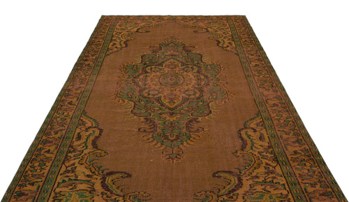 Load image 1 in gallery view. Rust-colored traditional rug with a central green and brown floral medallion and ornate border pattern.