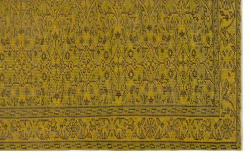 Load image 1 in gallery view. Olive green rug with a dark brown geometric lattice pattern and a decorative border.