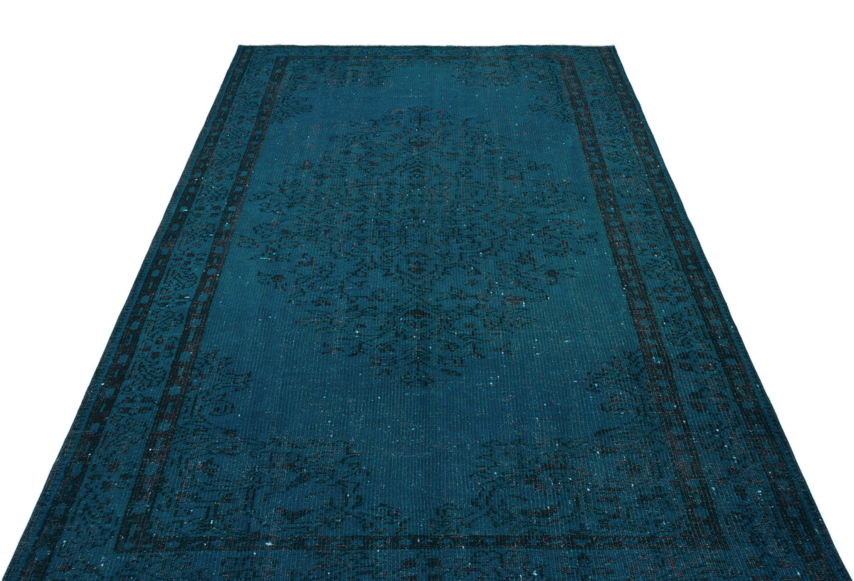 Teal and black distressed rug with a traditional central medallion and ornate border pattern on a white background.