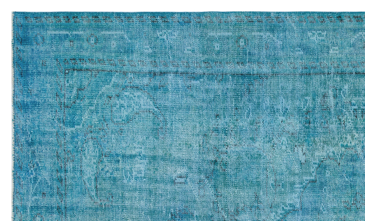 Teal distressed rug with a faded traditional medallion pattern on a white background.