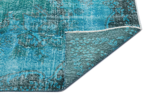 Load image 1 in gallery view. Teal and dark grey distressed rug with a faded traditional pattern, shown with a corner folded over on a white background.