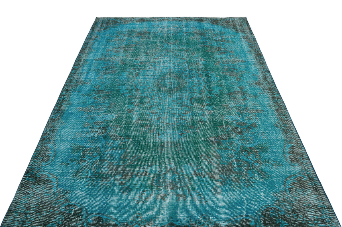 Teal and black distressed traditional rug with a central medallion pattern on a white background.