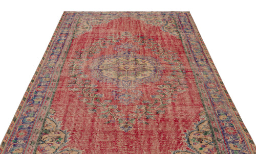 Load image 1 in gallery view. Distressed red vintage-style rug with a central medallion, blue and beige floral motifs, and a decorative border.