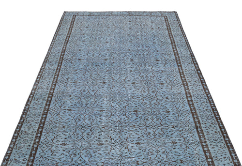 Load image 1 in gallery view. Light blue and dark brown vintage-style rug with an intricate repeating floral pattern and a bordered edge.